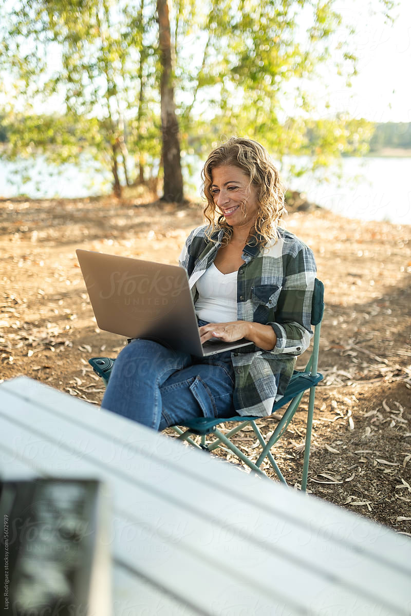 young woman with laptop in nature