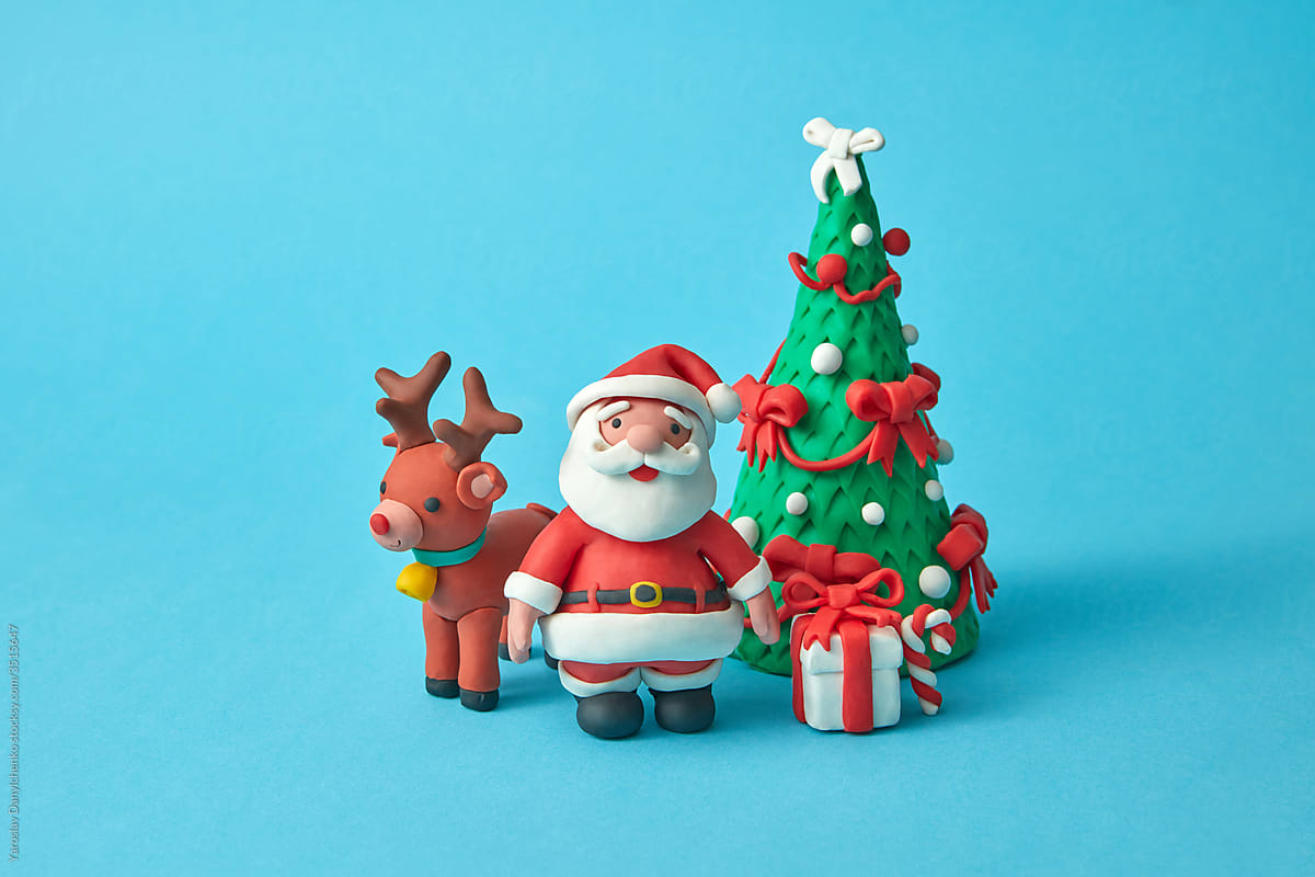 Craft plasticine Santa Claus with deer, tree and gifts.