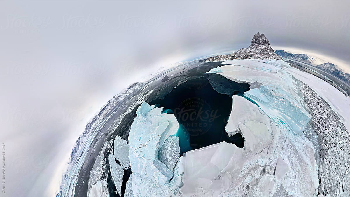 Winter sheet ice on sea with icebergs - polar tiny planet