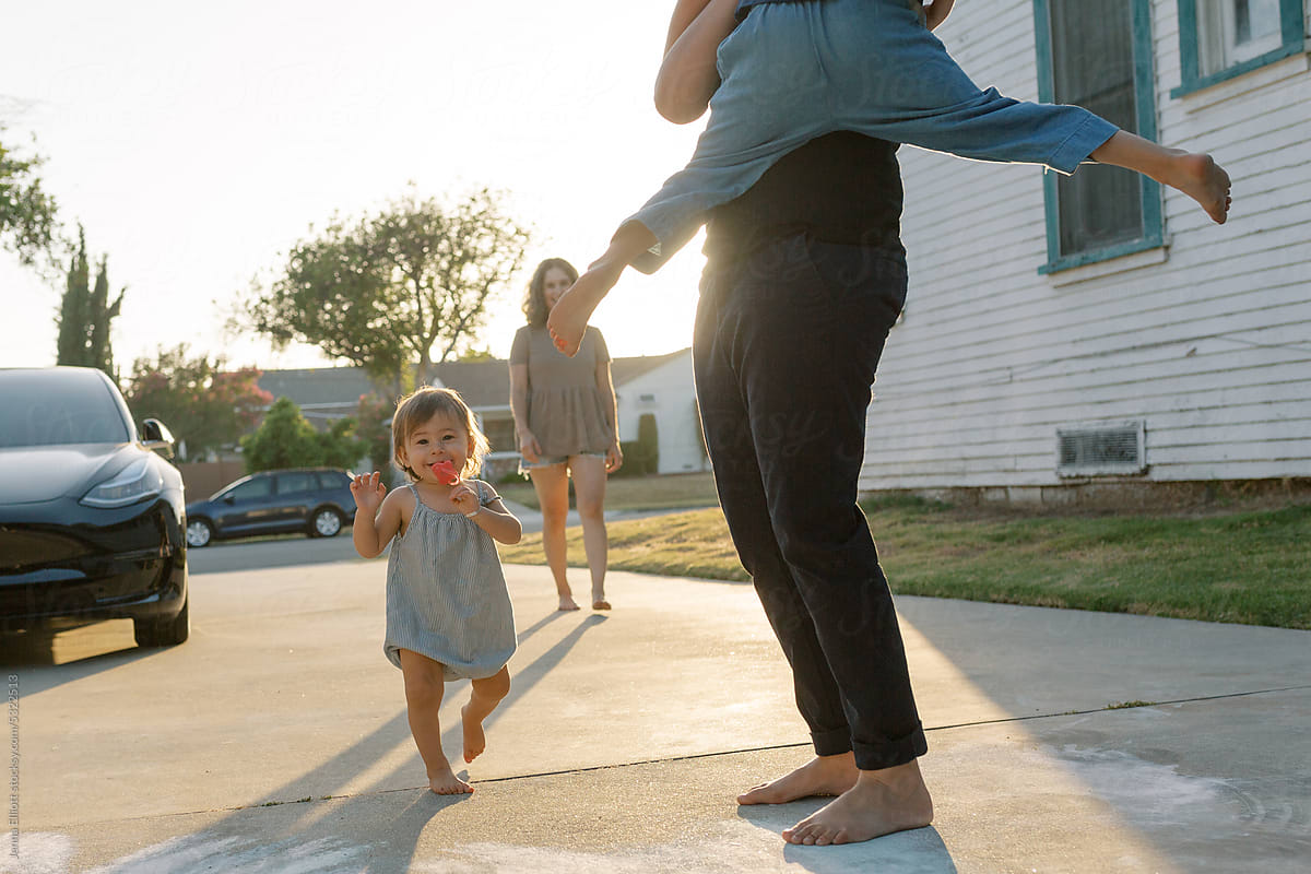 Family Plays In Driveway at Golden Hour