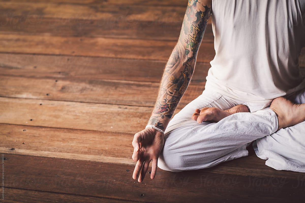 Tattooed Man Meditating in the Lotus Pose (Padmasana)