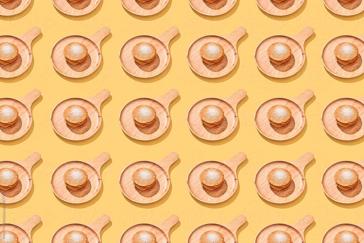 Multiple pancakes on a pastel coloured background