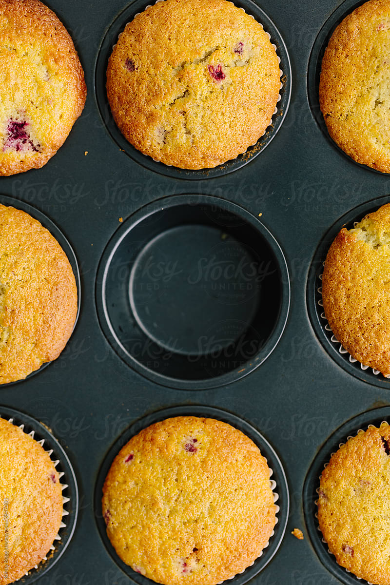 Tray of raspberry muffins with one missing