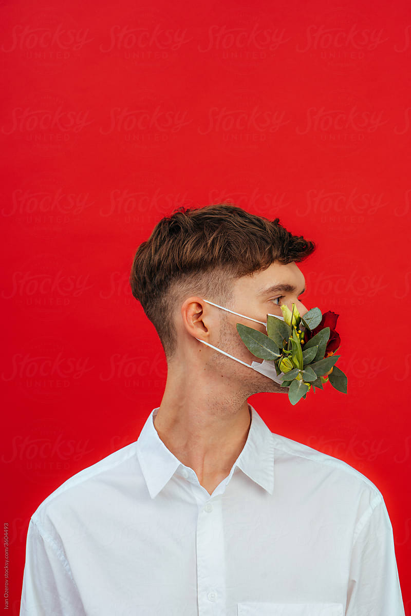 young man in a flower mask in profile