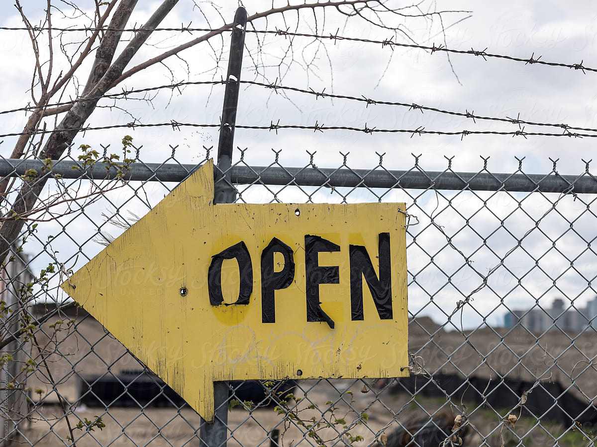 \'Open\' sign on a fence