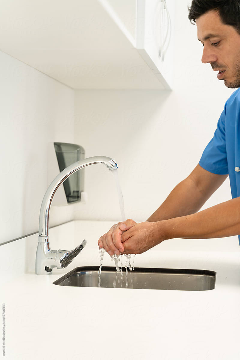 male doctor washing hands at hospital