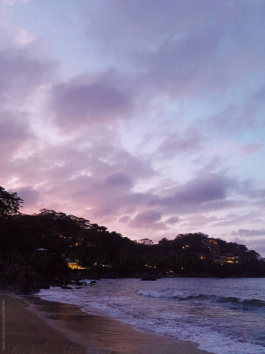 Colorful pink clouds over the beach and ocean