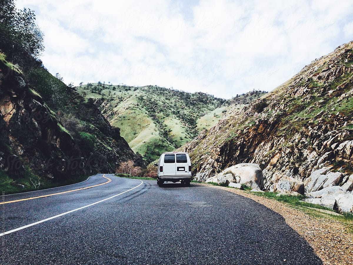 White Van on Windy Road with Beautiful Green Canyon
