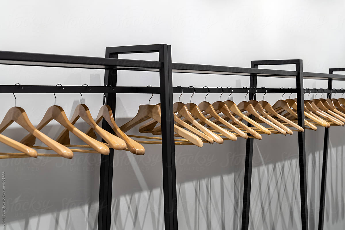 Light wood hangers on clothes rail indoors