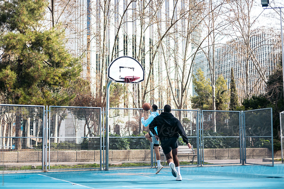 Men playing basketball in the city