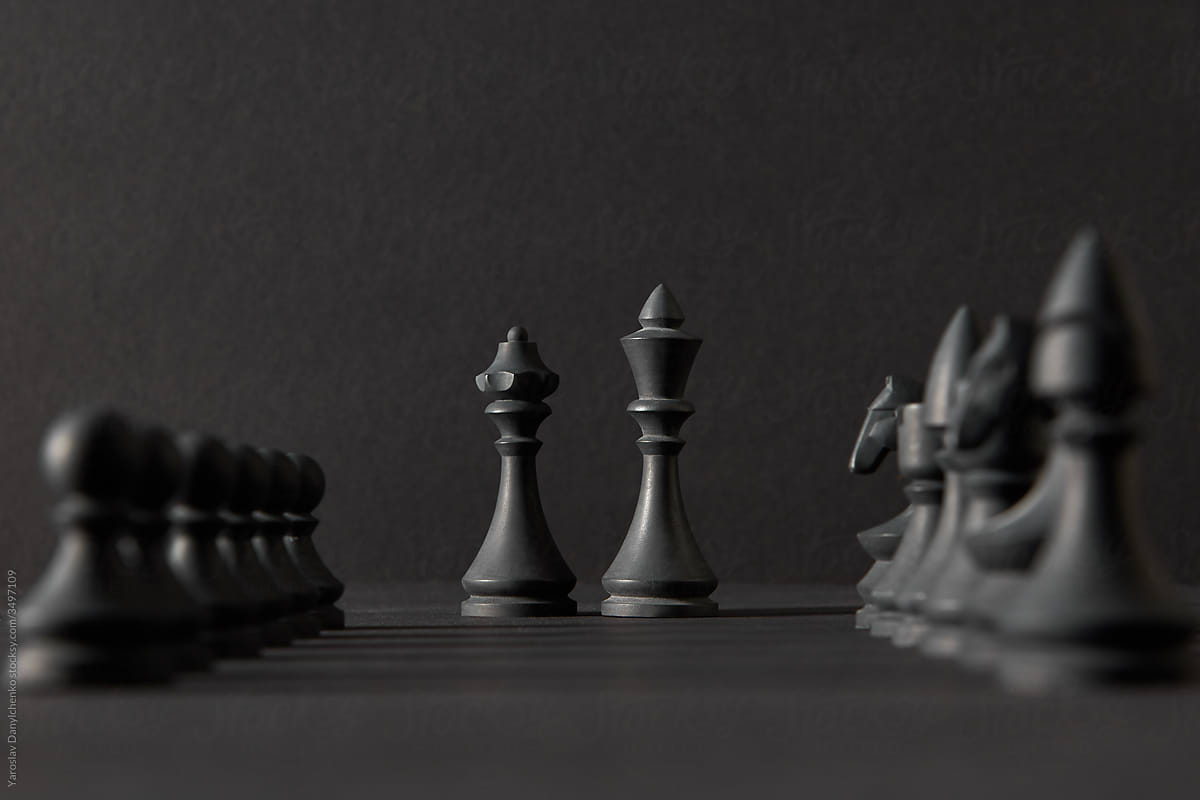Set from black chess figures against dark background.