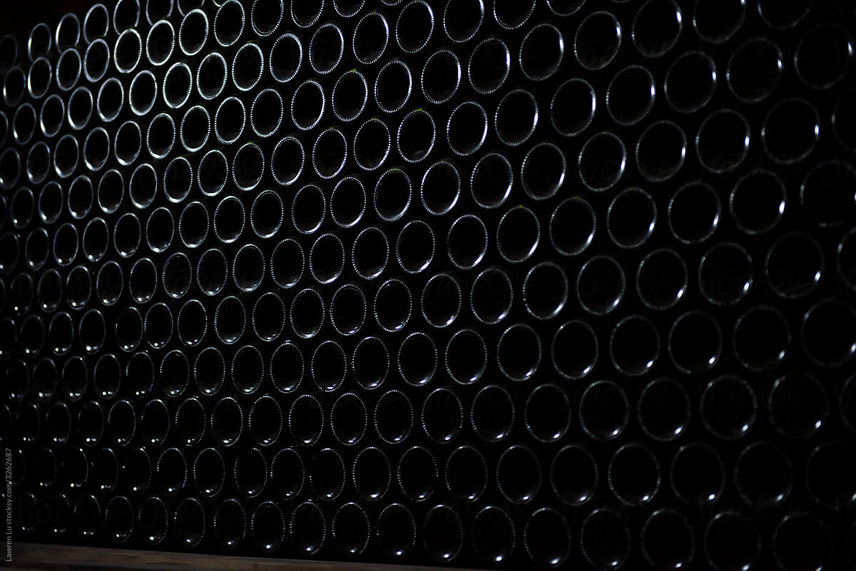 Wine bottles in wine cellar, row of glass bottles
