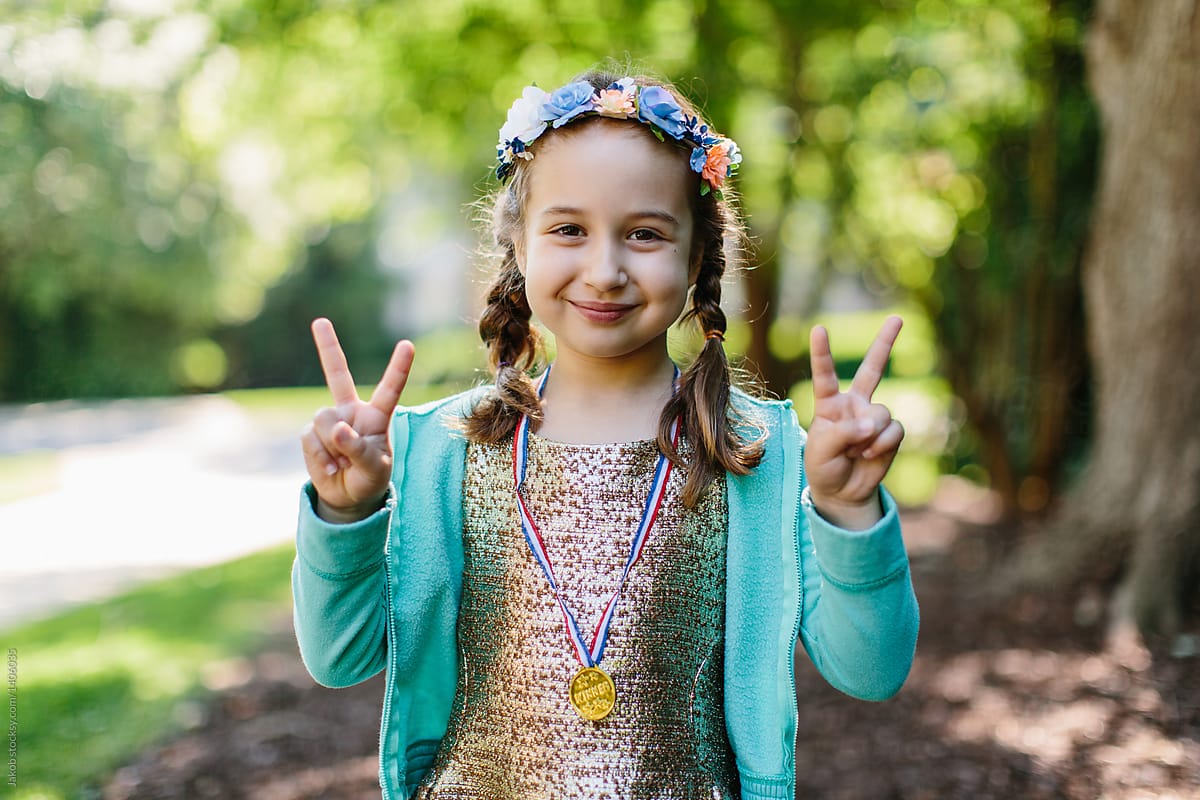 Portrait of a beautiful young girl wearing  a medal around her neck