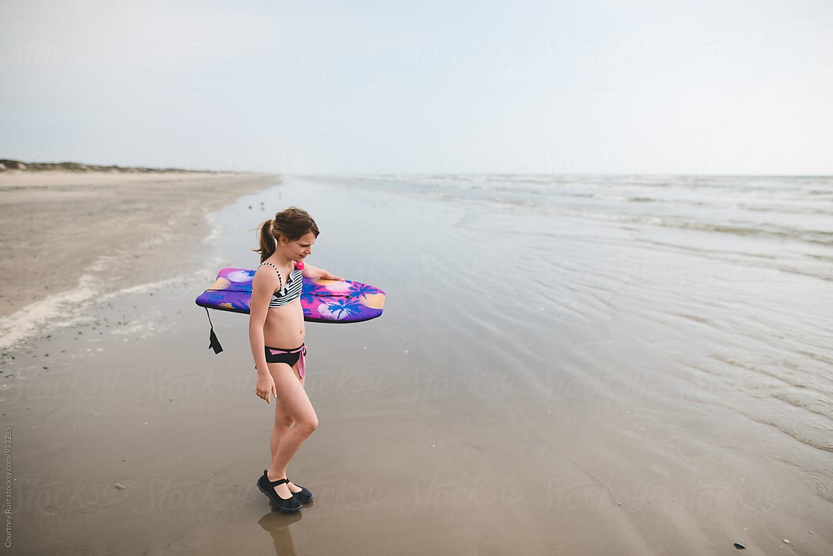 Shy Little Girl In Bathing Suit On Beach by Stocksy Contributor