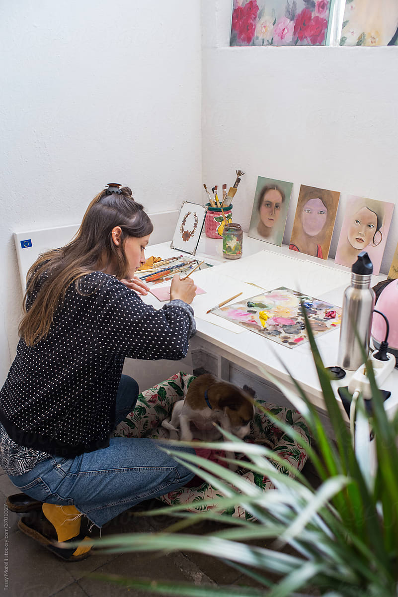 Young artist painting in her studio