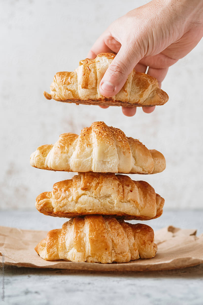 Hand making a croissant tower