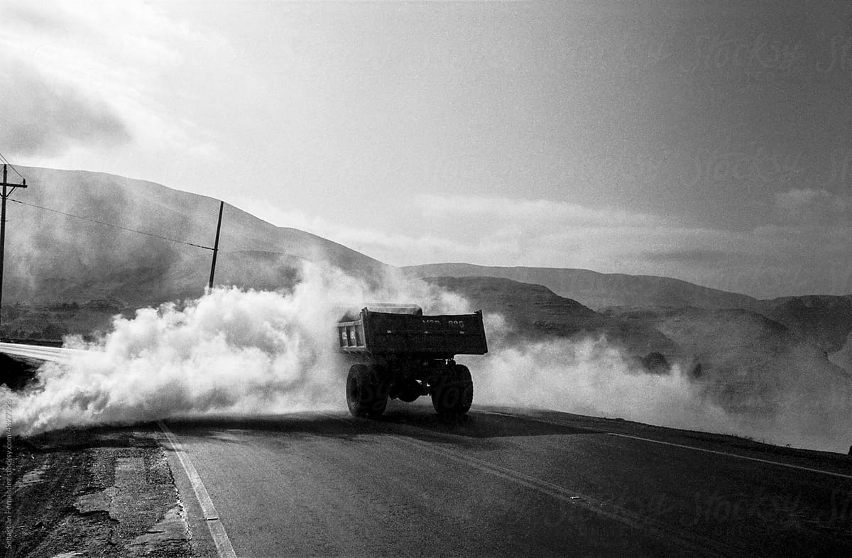 Truck in the desert of Peru passing through a smoke screen