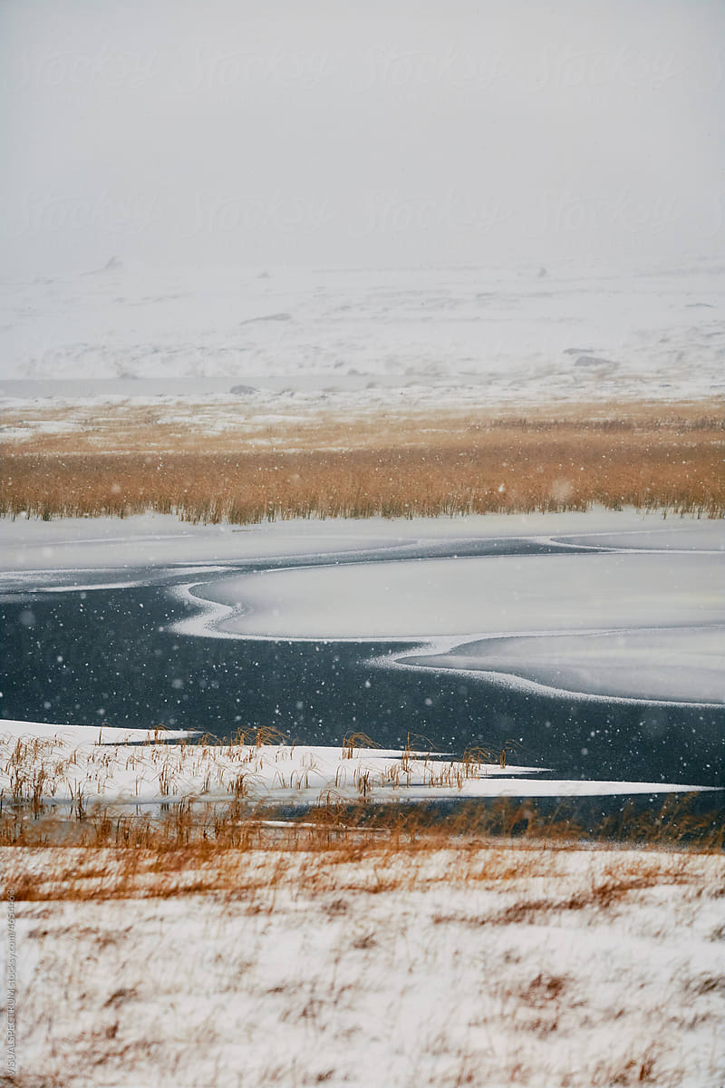 Semi-Frozen Lake With Heavy Snowfall