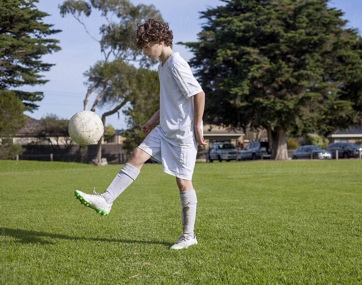 Boy practising soccer football skills