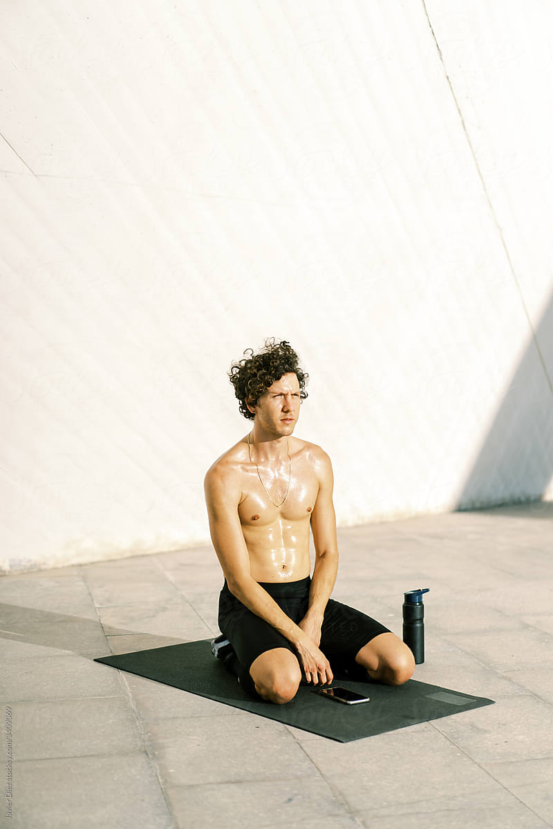 Sweaty sportsman resting during training