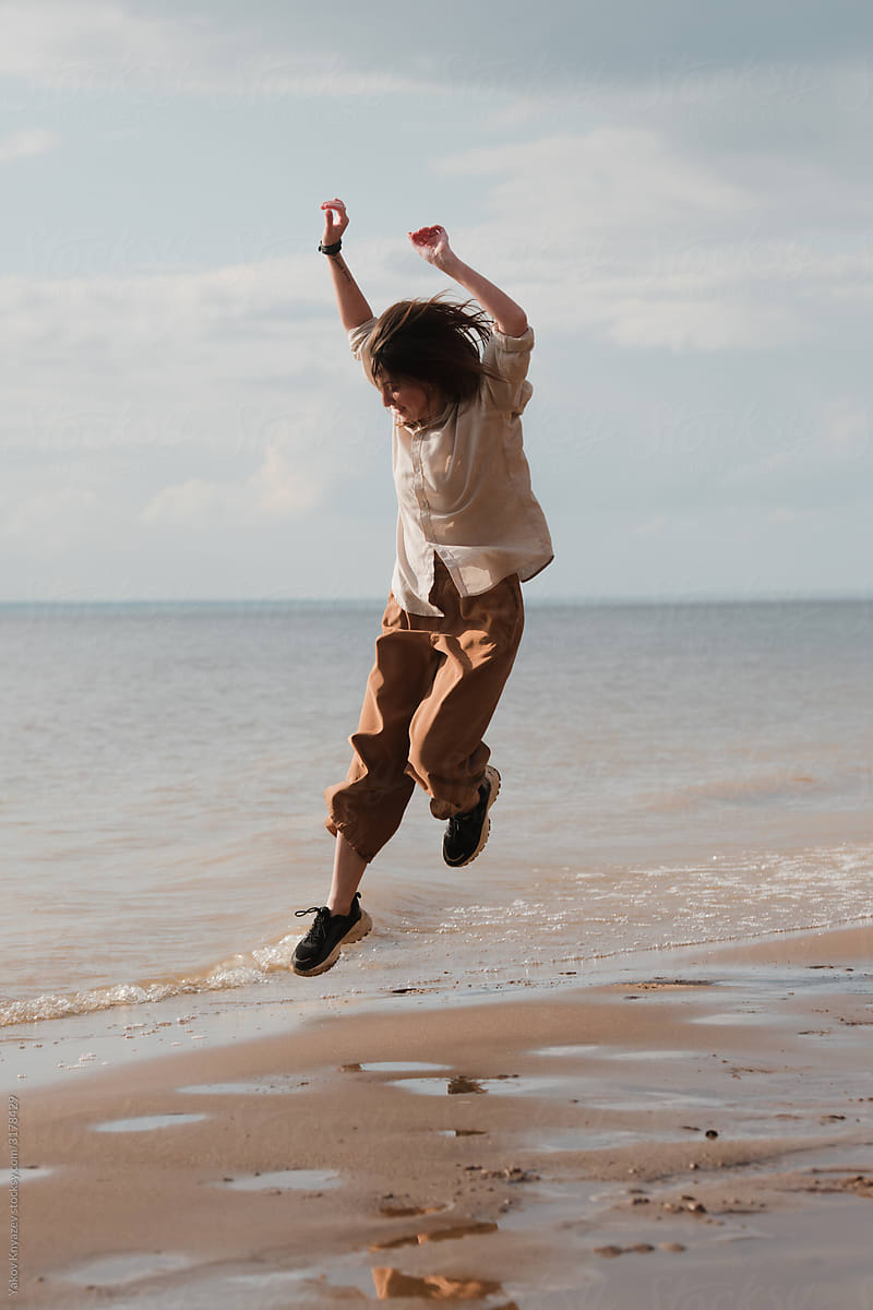 Professional dancer jumping high on the beach
