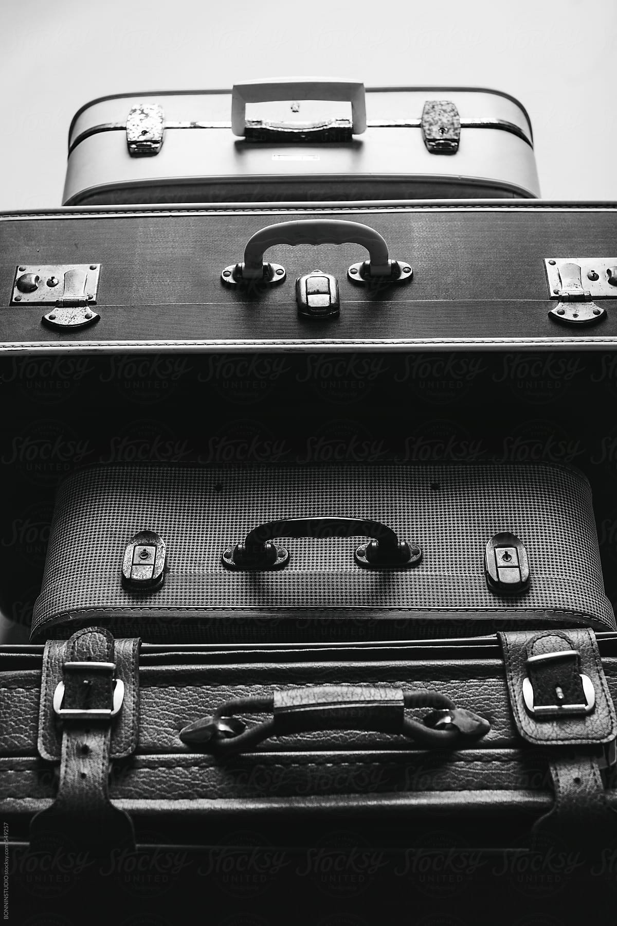 Stack of vintage suitcases. Black and white photo.