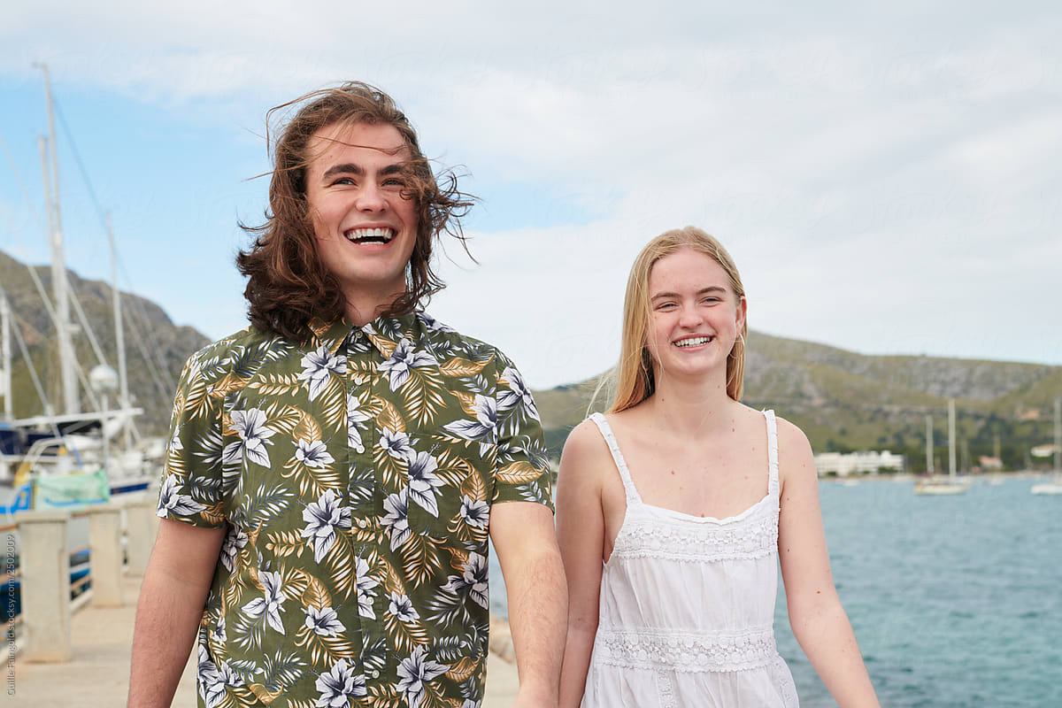 Smiling teenage couple on pier