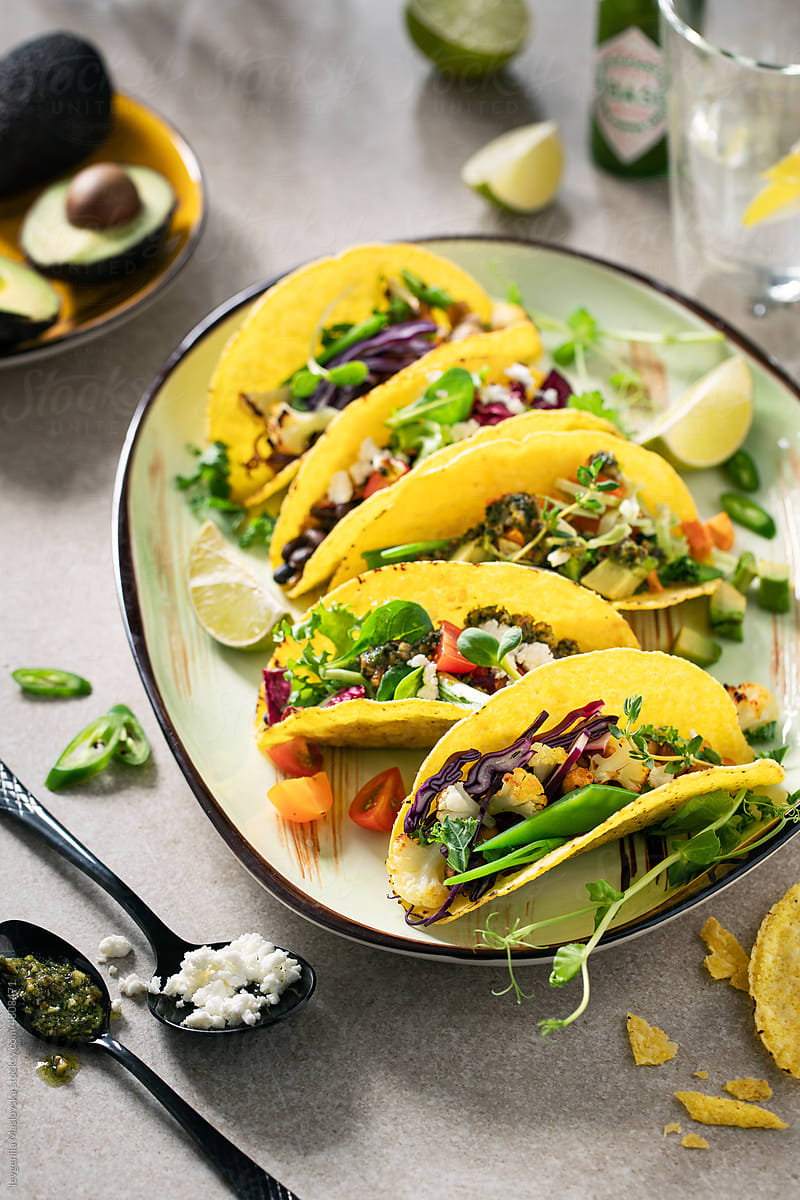 Healthy vegetarian tacos on a plate with ingredients