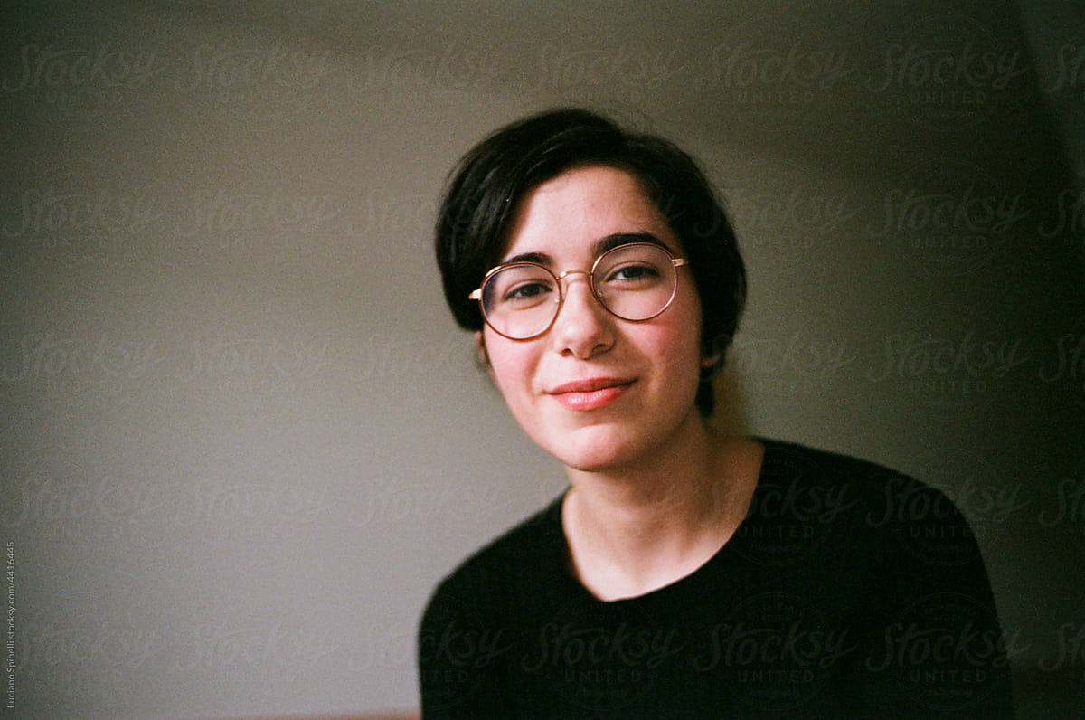 Portrait of a girl with short dark hair in a classroom