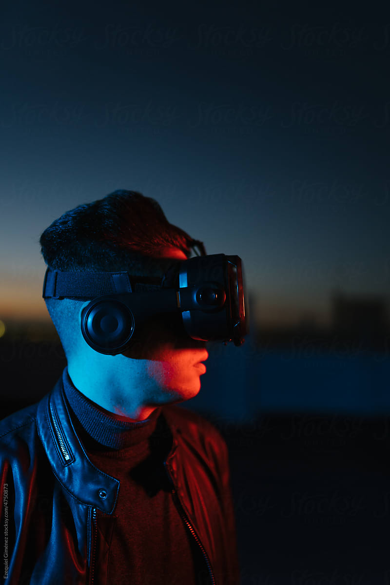 Man in VR headset in dark evening