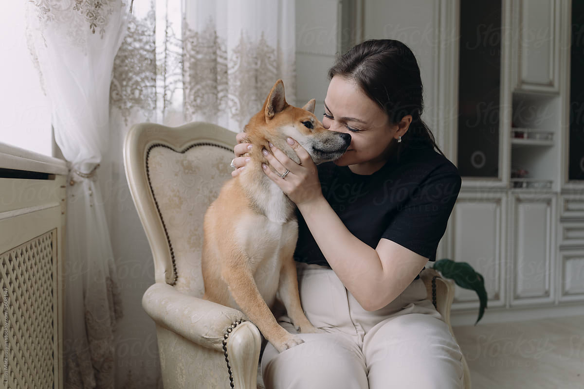 Woman Taking Care Her Dog At Home