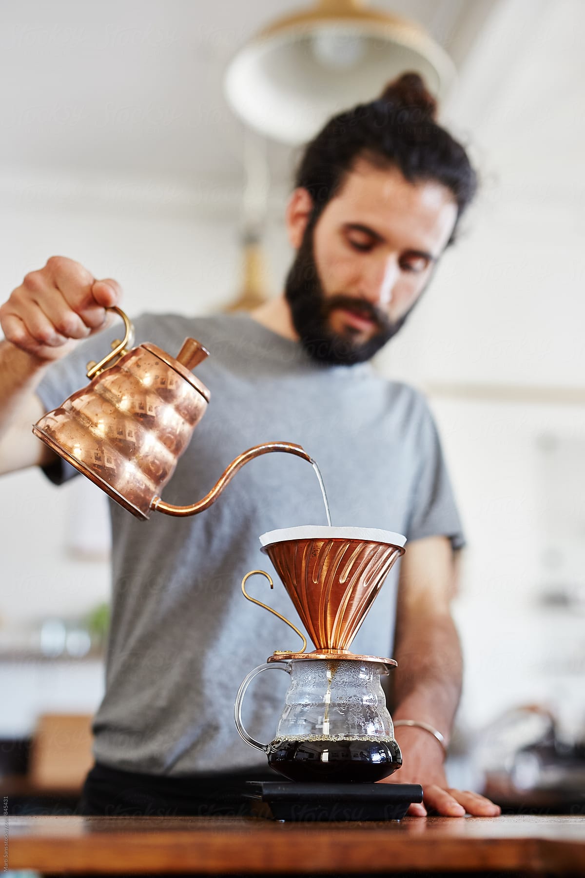 Barista pouring hot water through chemex