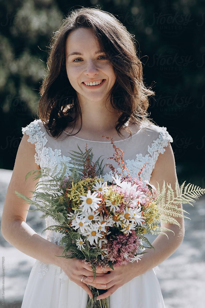 Portrait of happy gorgeous wife with bouquet