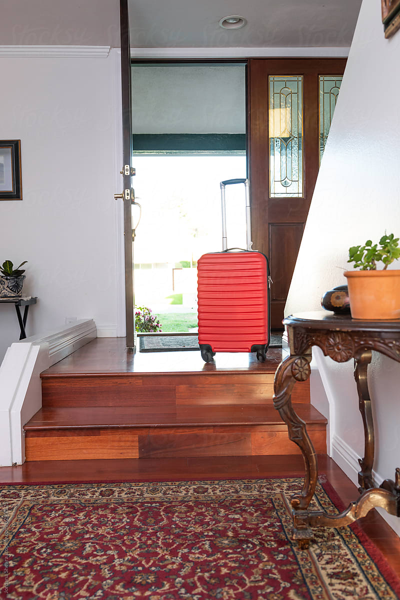 suitcase at an entryway with open doors