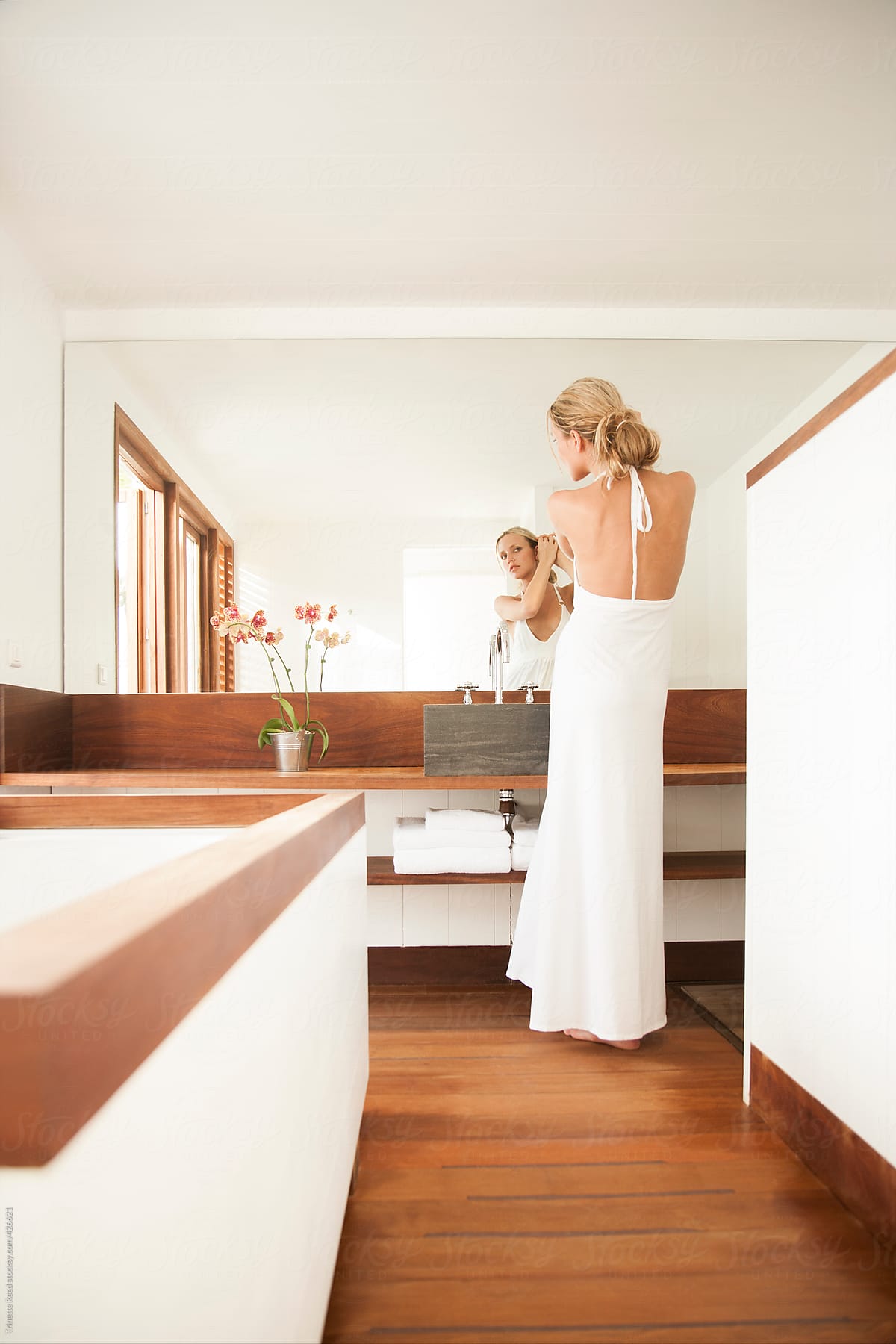 Woman getting ready in modern luxury bathroom