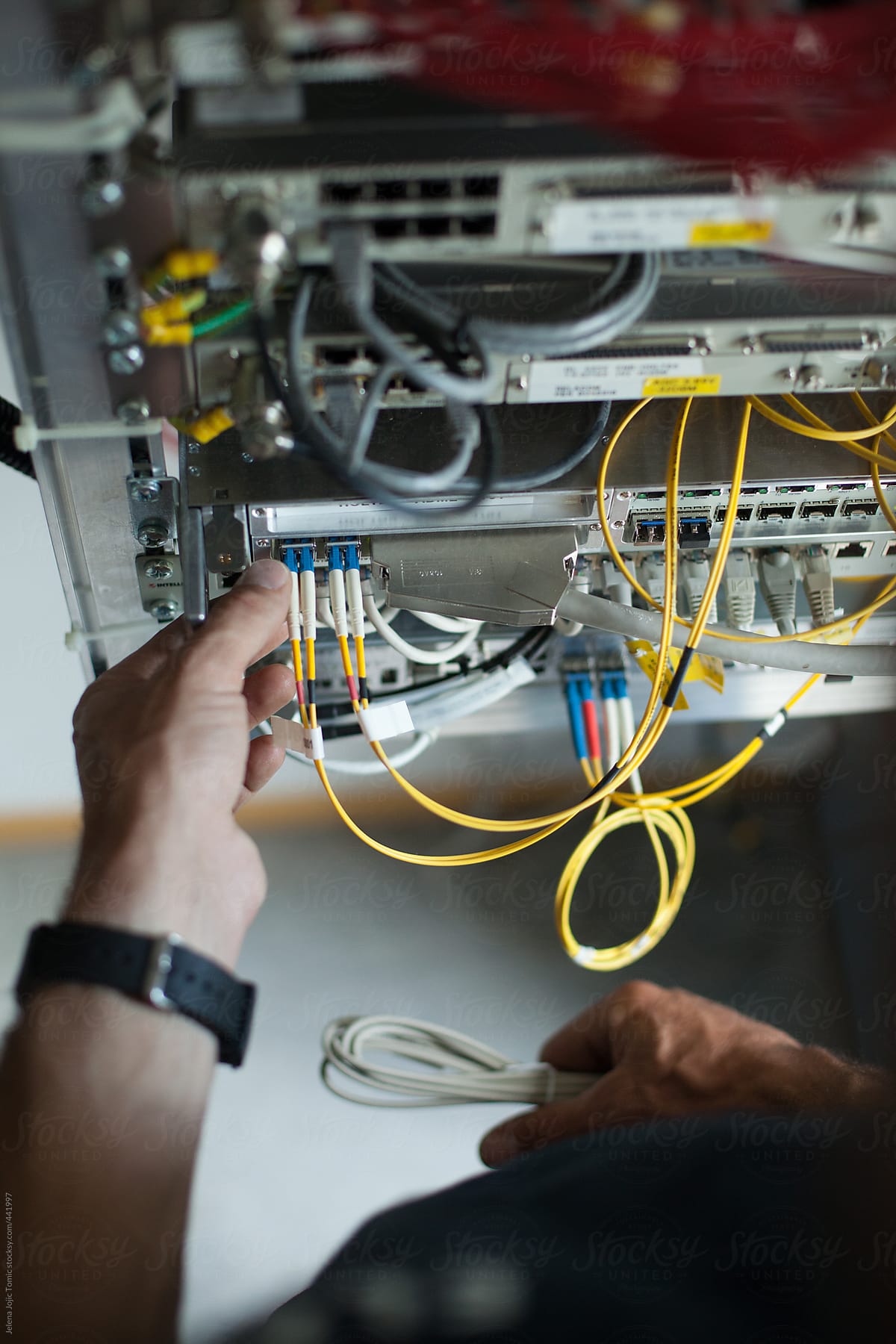 Technician works with optical cables, detail