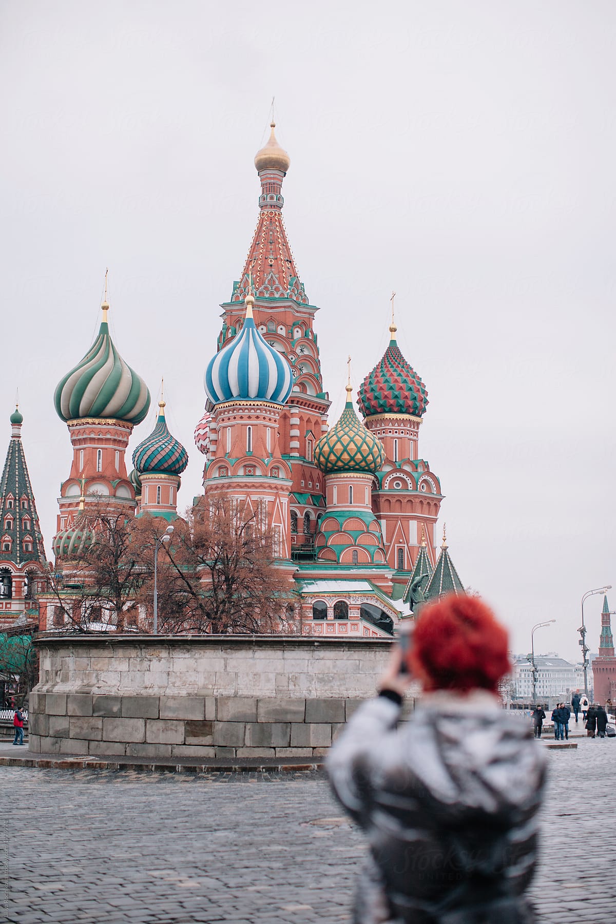 Unfocused girl taking picture of saint Basil\'s Cathedral in Moscow