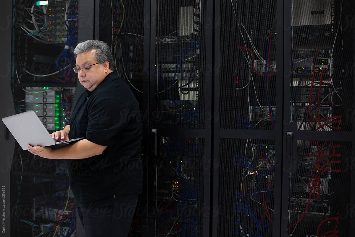 IT professional in data center filled with servers