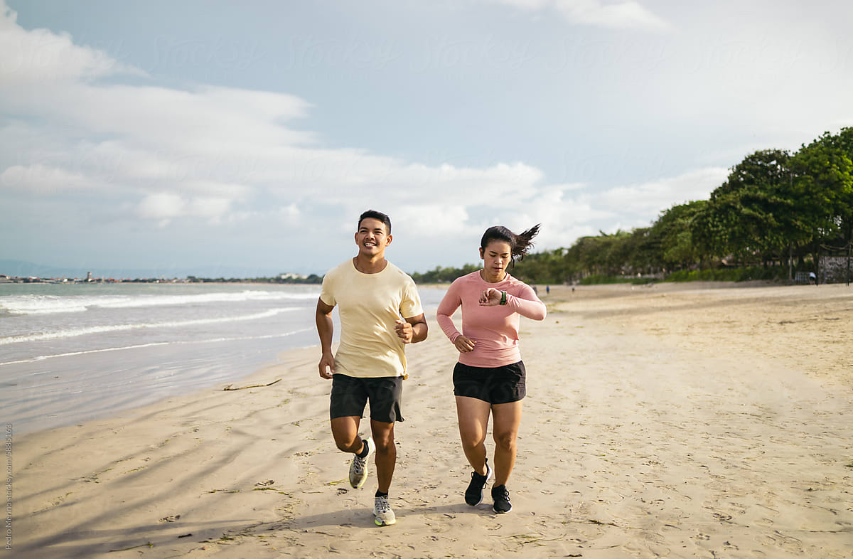 Southeast Asian friends running on the beach